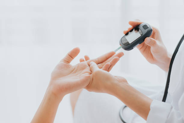 Understanding Diabetes | CareTutor | Social Care eLearning Doctor use glucosmeter checking blood sugar level from patient hand